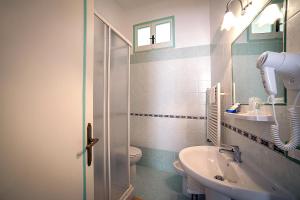 a bathroom with a sink and a toilet at Hotel L'Argine Fiorito in Atrani