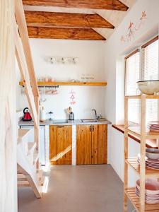 a kitchen with wooden cabinets and a staircase at Kraina Wetlina in Wetlina