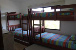 two bunk beds in a room with a window at Villa 24C Los Cabos Monterrico in Monterrico +32 photos