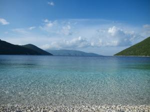 a large body of water with mountains in the background at Muses Studios Sami in Sami