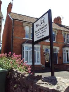 a no parking sign in front of a brick building at No. 23 in Wells