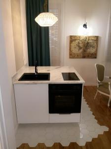 a white kitchen with a sink and a stove at Urbana 33 in Rome
