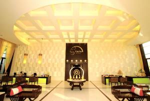 a lobby with chairs and a fireplace in a building at Kacha Resort & Spa, Koh Chang in Ko Chang