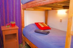 A bed or beds in a room at Casa Blanca Hostel