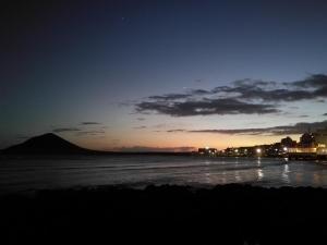 a view of a beach at night with the ocean at Apartment South Tenerife in San Isidro
