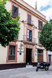 a motorcycle parked in front of a building at Casona de San Andrés in Seville
