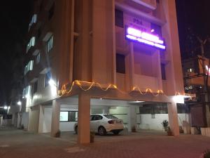 a car parked in front of a building at night at Sun Shine in Chennai