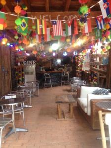 a room with tables and chairs and colorful flags at Mancora Apartments in Máncora