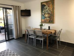 a dining room with a wooden table and chairs at Coonawarra Ensuite Unit B in Coonawarra