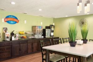 a fast food restaurant with a table and chairs at Baymont by Wyndham Warrenton in Warrenton