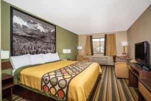a hotel room with a bed and a flat screen tv at Super 8 by Wyndham Kremmling in Kremmling