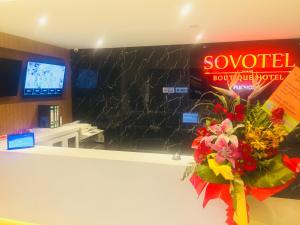a store counter with a bouquet of flowers and a sign at Sovotel @ Puchong in Puchong