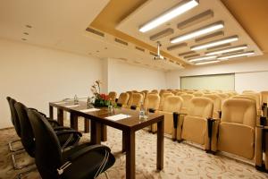 a conference room with a long table and chairs at Earth & People Hotel & SPA - Free Parking & Swimming Pool in Sofia