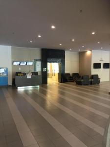 an empty lobby with couches and tables in a building at Meridin Medini Muslim Condo in Nusajaya