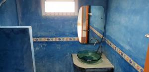 a blue bathroom with a sink and a mirror at Phuttharaksa Resort in Ko Larn +59 photos