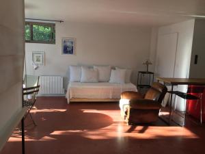 a bedroom with a bed and a table and a chair at 20B - KERMARQUER - STUDIO 1 48m² in La Trinité-sur-Mer