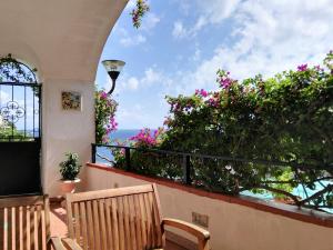 a balcony with a view of the ocean and flowers at Casa Vacanze Bouganvillea in Cetara