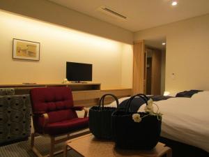 Uma televisão e/ou sistema de entretenimento em Japanese Style Hotel Isomura