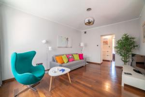 a living room with a couch and a chair at City Center Boutique Apartment in Warsaw