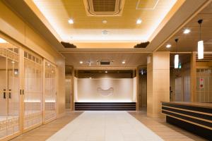 a dressing room with a large screen in the middle at Japanese Style Hotel Isomura in Kesennuma