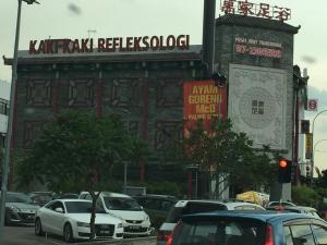 ulica z samochodami zaparkowanymi przed budynkiem w obiekcie Skyloft Muslim Suite w mieście Johor Bahru