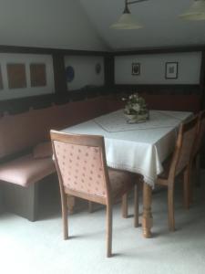 a table with two chairs and a table with flowers on it at Ferienwohnung Grothoff in Olsberg