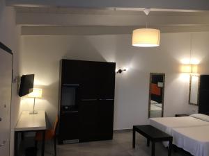 a bedroom with a bed and a black cabinet at Residenze La Villa in Foggia
