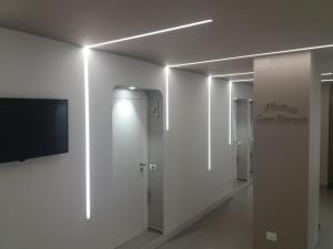 a row of stalls in a bathroom with a television at Maison Saint Honorè in Foggia