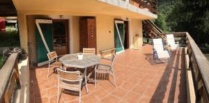 a patio with a table and chairs on a house at la terrasse in Saint-Étienne-de-Tinée +1 photo