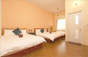 En eller flere senge i et værelse på Taitung city-cottage B&B