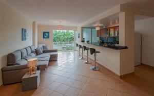 a living room with a couch and a bar at Apartment Blue Sea in Paul do Mar