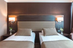 Postel nebo postele na pokoji v ubytování Premier Hotel Rus