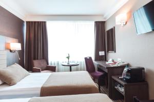 Postel nebo postele na pokoji v ubytování Premier Hotel Rus