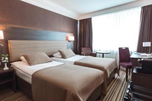 Postel nebo postele na pokoji v ubytování Premier Hotel Rus