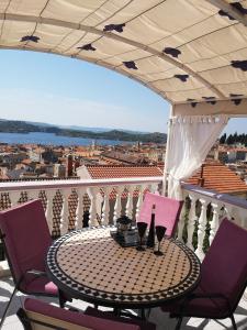 a table and chairs on a balcony with a view at Apartment Lorena in Šibenik