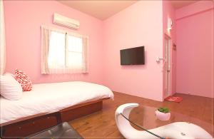 Et tv og/eller underholdning på Taitung city-cottage B&B