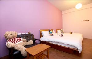 En eller flere senge i et værelse på Taitung city-cottage B&B