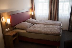 Postel nebo postele na pokoji v ubytování La Flamme Wertheim garni