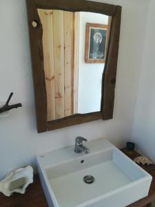 a bathroom with a white sink and a mirror at Sea Breeze Ecological Villa in Agia Galini