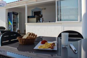 a table with a plate of breakfast food on it at Hotel Artur2 in Ksamil