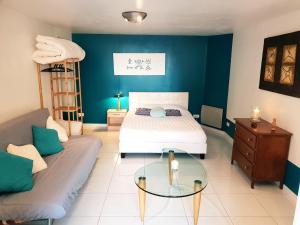 a bedroom with a bed and a couch at Charmant Studio en Champagne - Sparkling-Life in Matougues