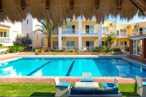 a swimming pool in front of a hotel at Evelin Hotel in Platanes
