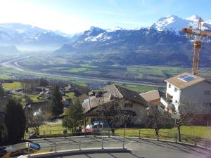 a view of a village with mountains in the background at Hotel Restaurant Kulm in Triesenberg