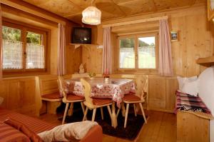 a dining room with a table and chairs at Villa Insam Apartment in Selva di Val Gardena