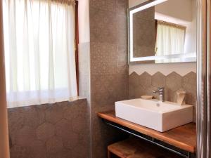 a bathroom with a white sink and a mirror at Villa Giardino - Flowers in Molveno