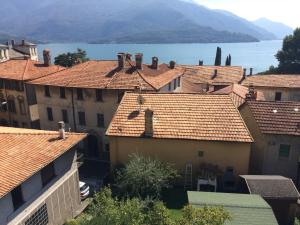 a group of houses with a lake in the background at Casa Sergio in Gravedona