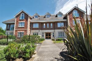 a large brick house with a pathway in front of it at Spacious 2-Bedroom Apartment with Parking in Windsor 4LA by Accommodation Windsor in Windsor
