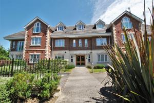a large brick house with a pathway in front of it at Spacious 2-Bedroom Apartment with Parking in Windsor in Windsor