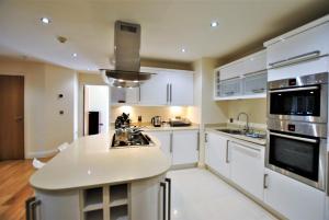 a kitchen with white cabinets and a white counter top at Spacious 2-Bedroom Apartment with Parking in Windsor 4LA by Accommodation Windsor in Windsor