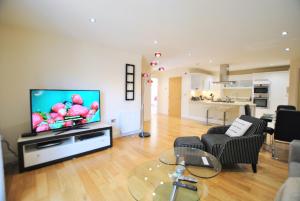 a living room with a flat screen tv on a wall at Spacious 2-Bedroom Apartment with Parking in Windsor 4LA by Accommodation Windsor in Windsor